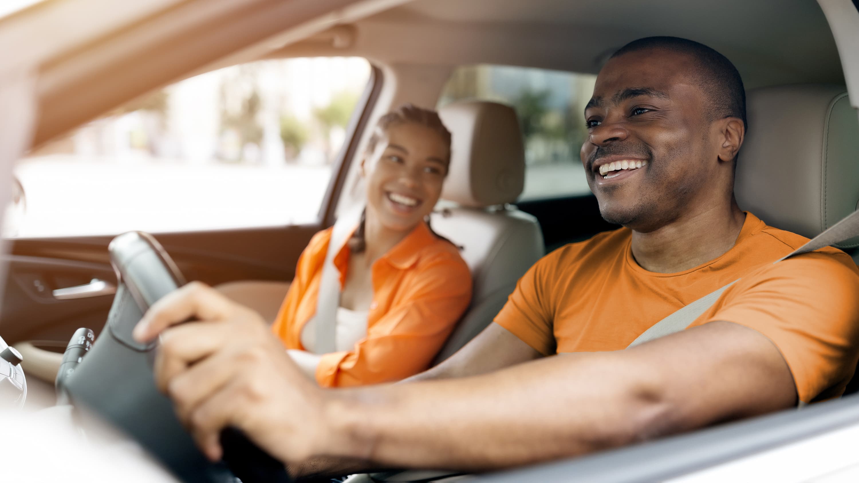 Couple in car orange shirts